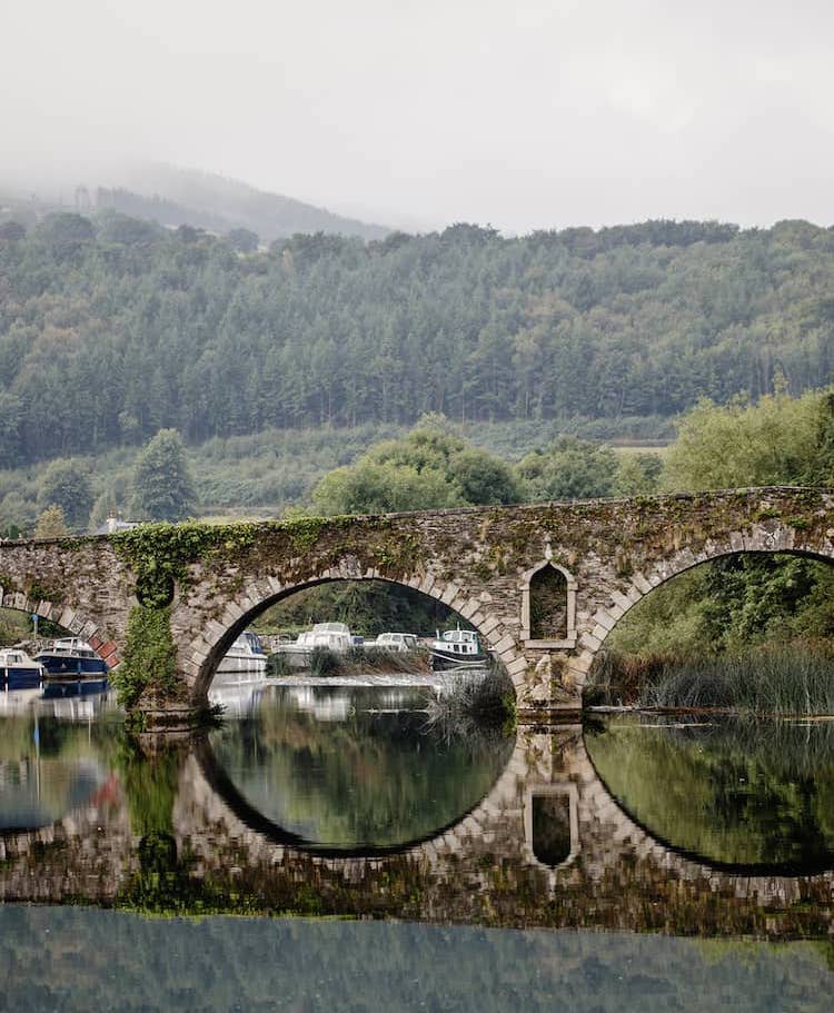 Graiguenamanagh bridge, Kilkenny against a backdrop of evergreen trees