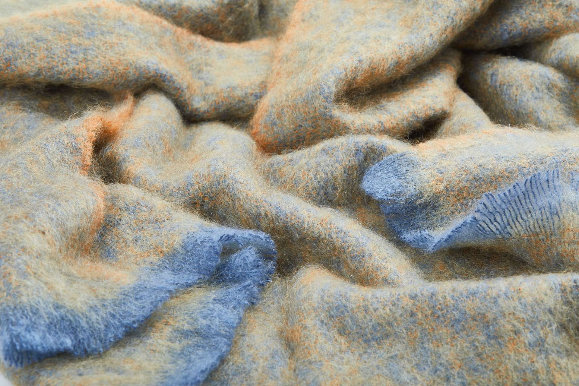 A representation of crumpled Ochre Clash Mohair Throw Blanket